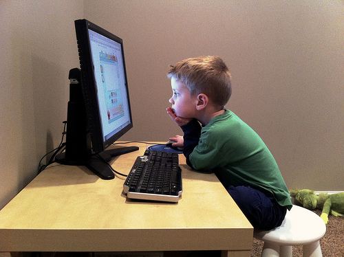 Kid watching computer screen